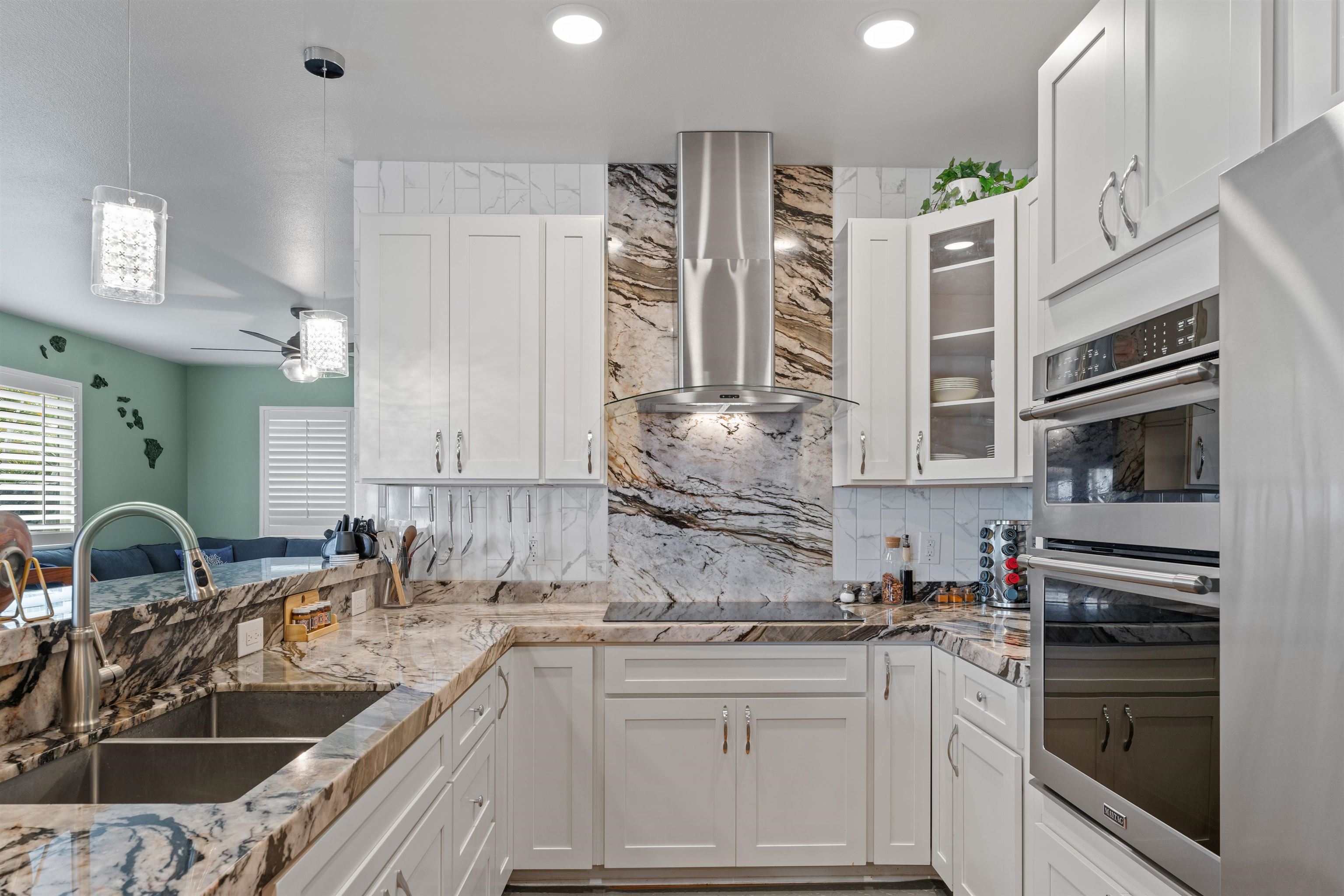 112 Kili'o'opu Street Wailuku, HI 96793 - Photo 3 of 49 a kitchen with stainless steel appliances a sink stove and cabinets
