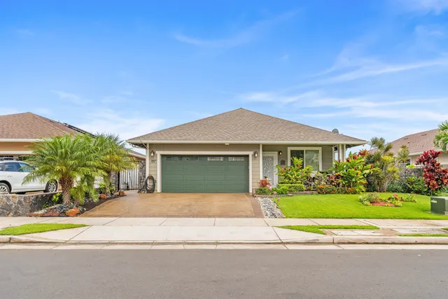 a view of a house with a yard and palm trees