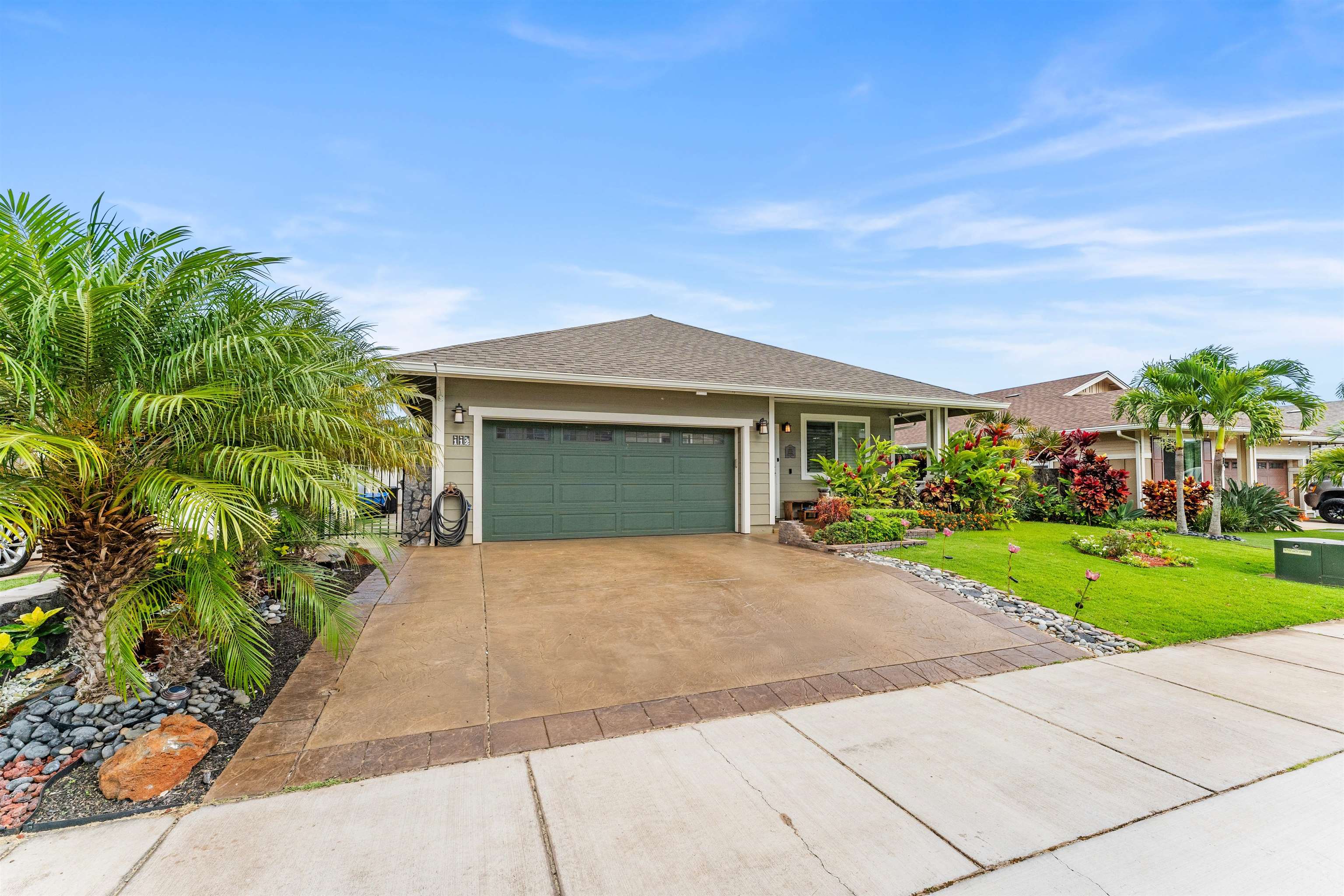112 Kili'o'opu Street Wailuku, HI 96793 - Photo 5 of 49 a front view of a house with a yard and a garage