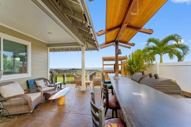 a living room with furniture and floor to ceiling windows