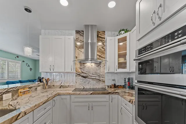 a kitchen with stainless steel appliances granite countertop a sink stove and cabinets