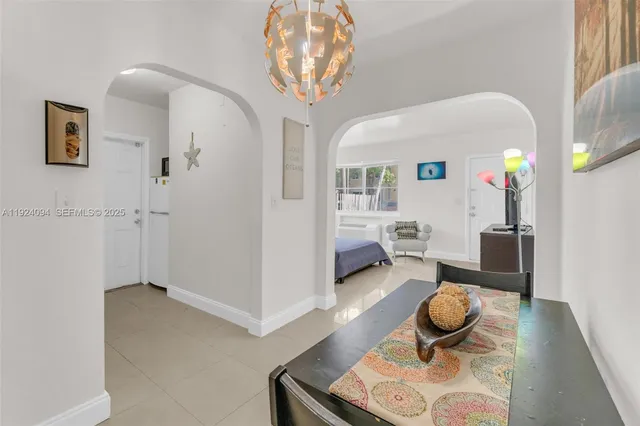 a front view of a house with a yard and potted plants