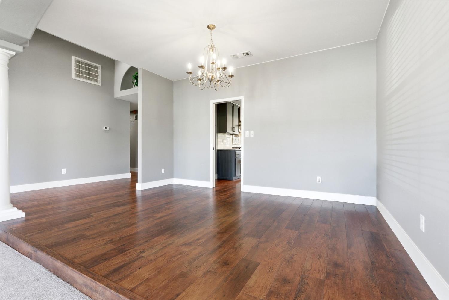 13201 Meacham Road Bakersfield, CA 93314 - Photo 16 of 62 a view of a room with wooden floor and chandelier