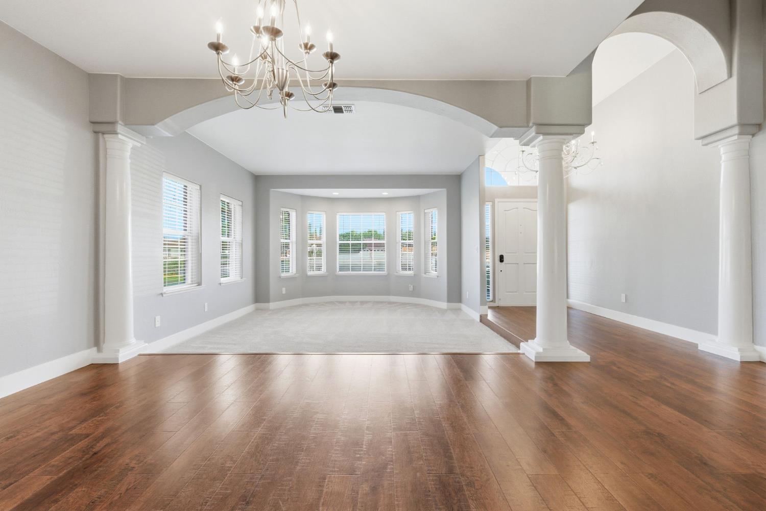 13201 Meacham Road Bakersfield, CA 93314 - Photo 18 of 62 a view of an empty room with wooden floor and a window