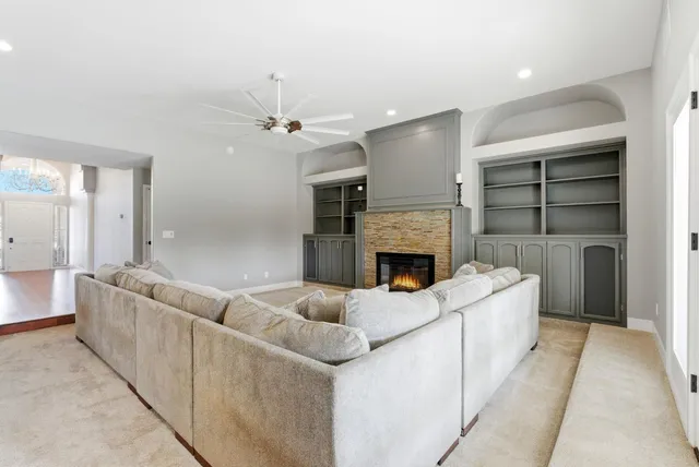 a living room with furniture and a large mirror