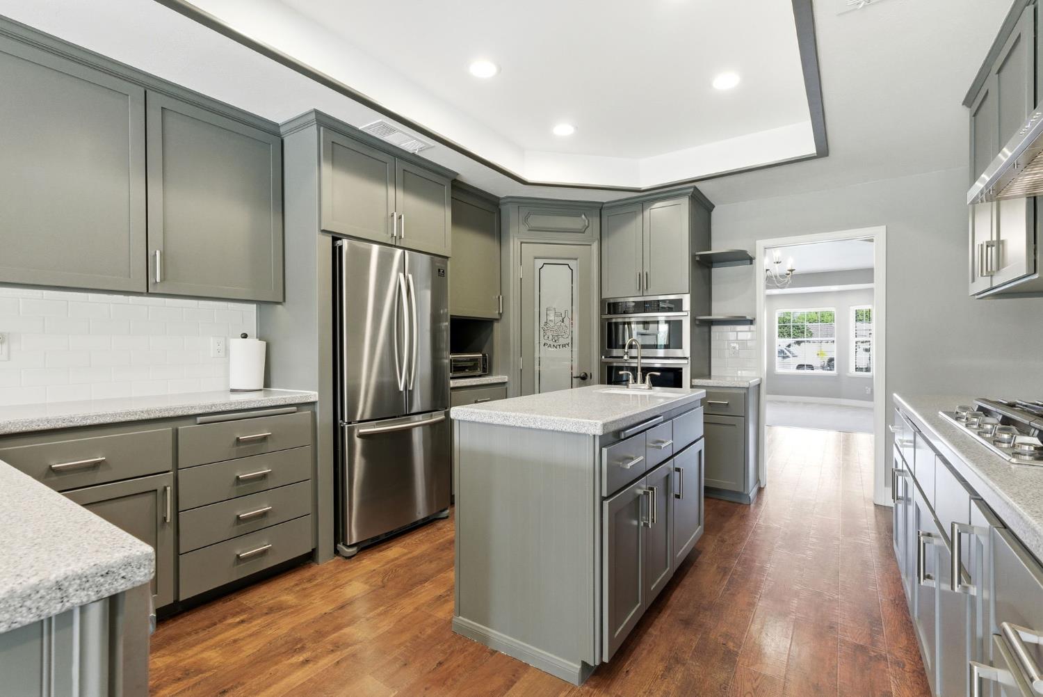 13201 Meacham Road Bakersfield, CA 93314 - Photo 29 of 62 a kitchen with stainless steel appliances granite countertop a stove and a refrigerator