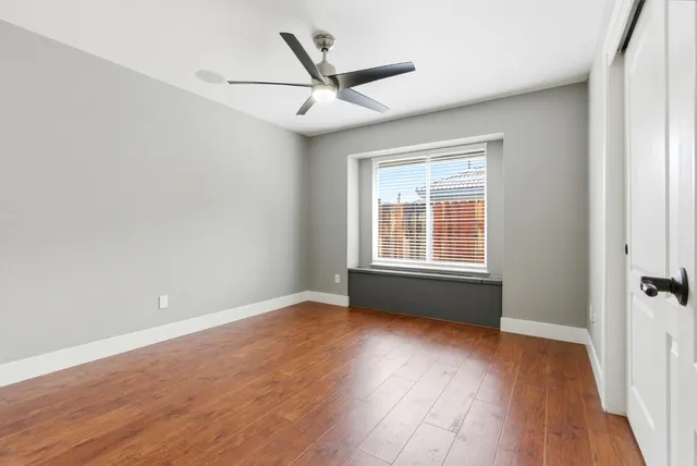 a spacious bedroom with a bed and a flat screen tv