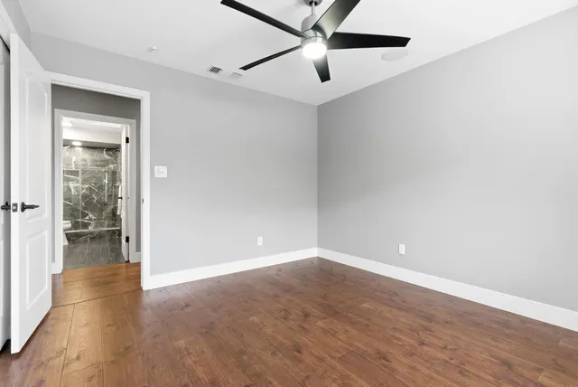 a bedroom with a bed a flat screen tv and a fireplace