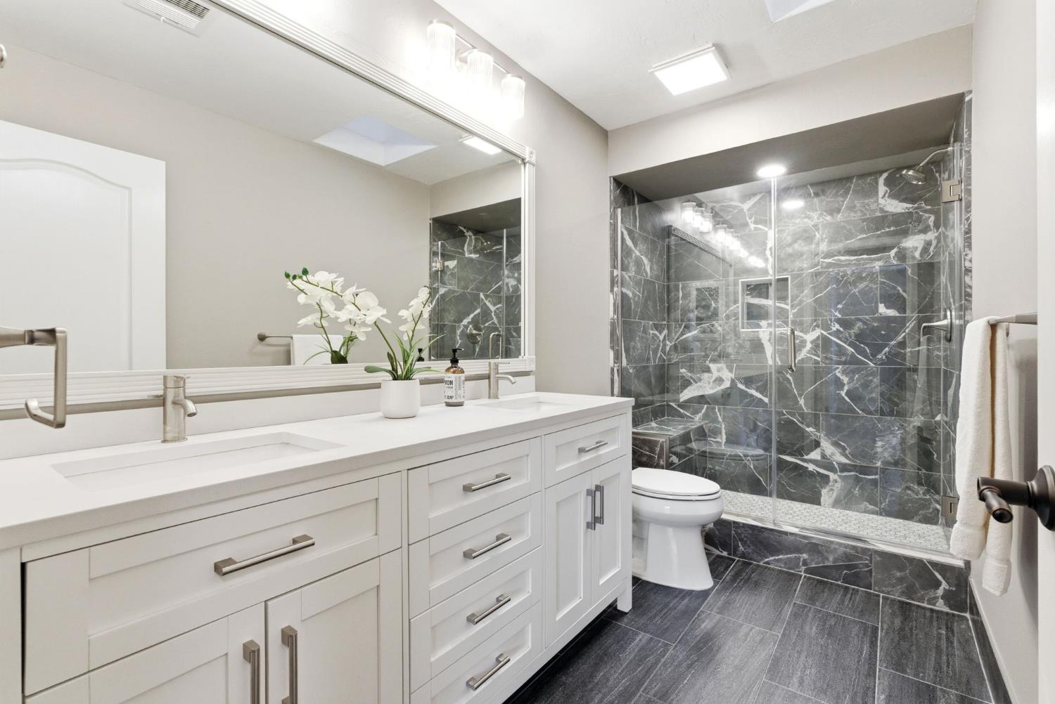 13201 Meacham Road Bakersfield, CA 93314 - Photo 43 of 62 a bathroom with a double vanity sink toilet and shower