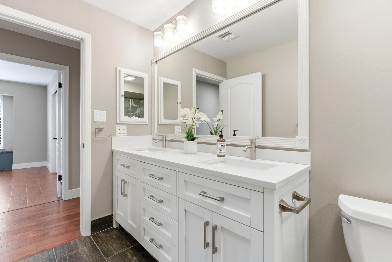 13201 Meacham Road Bakersfield, CA 93314 - Photo 44 of 62 a bathroom with a sink a toilet and a mirror
