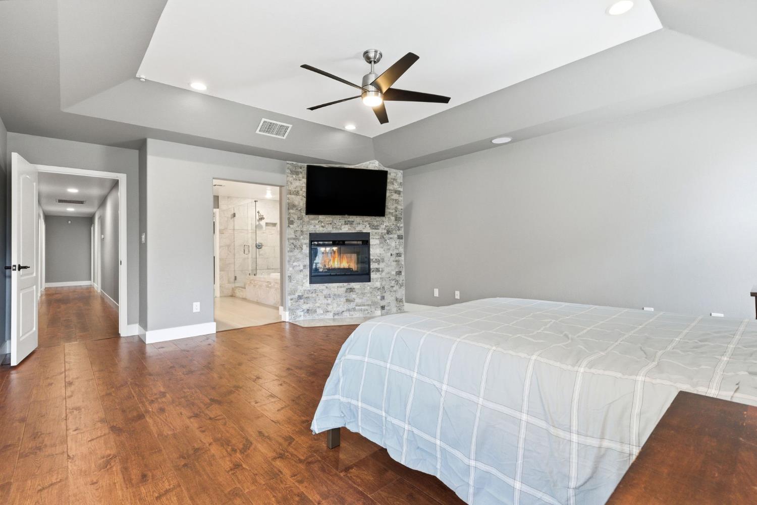 13201 Meacham Road Bakersfield, CA 93314 - Photo 46 of 62 a spacious bedroom with a bed and a flat screen tv