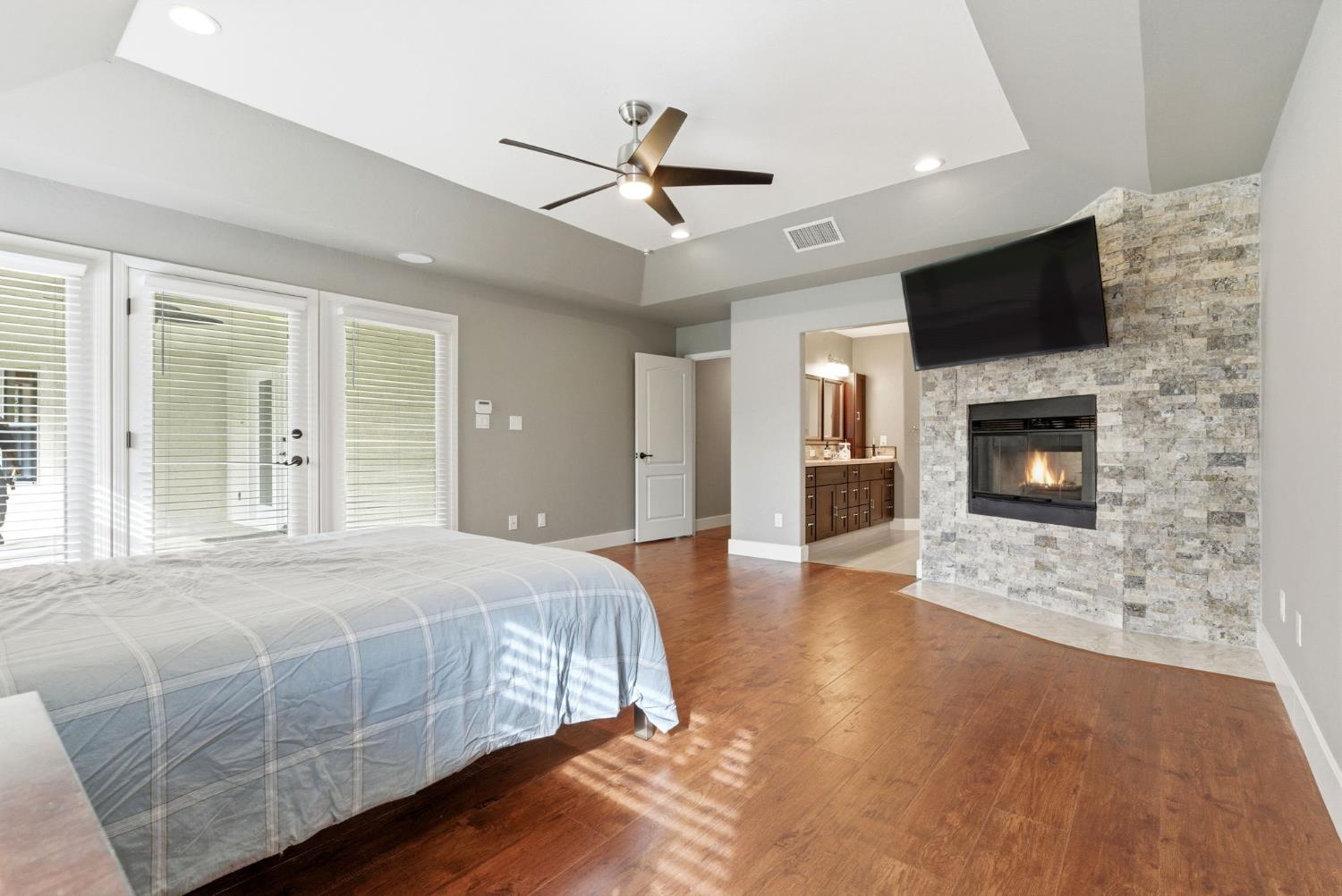 13201 Meacham Road Bakersfield, CA 93314 - Photo 47 of 62 a spacious bedroom with a bed and a flat screen tv