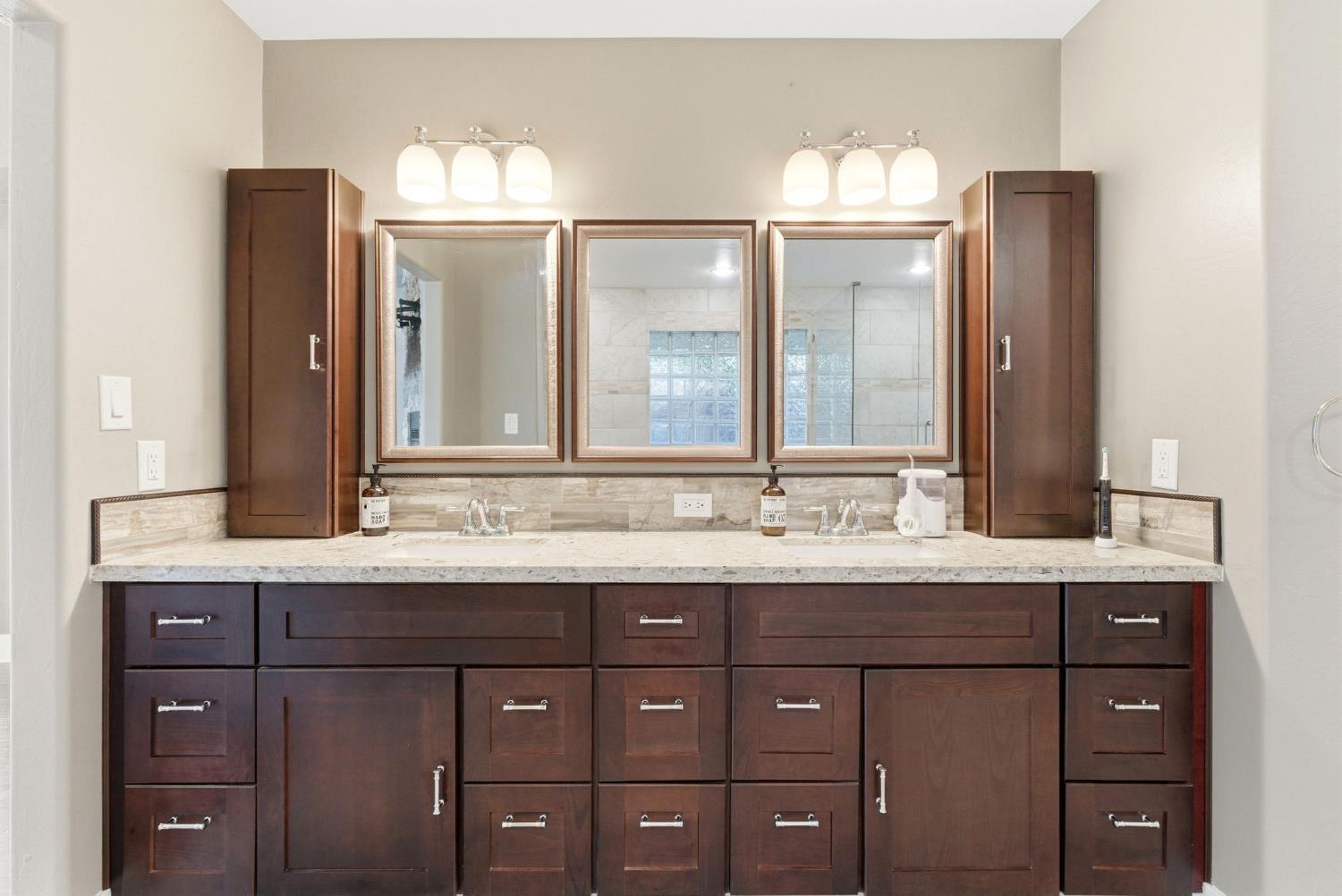 13201 Meacham Road Bakersfield, CA 93314 - Photo 52 of 62 a bathroom with a granite countertop sink and a mirror