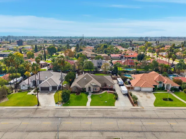 an aerial view of residential houses with yard