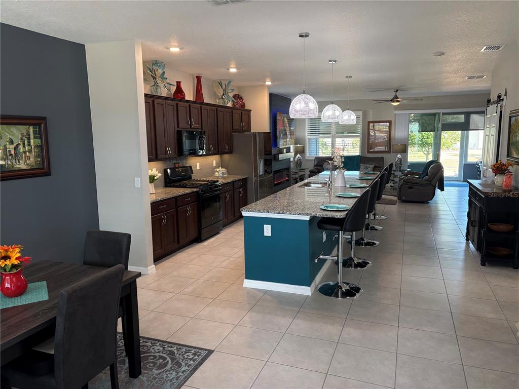 7819 Southwest 88th St Road Ocala, FL 34476 - Photo 5 of 30 a large kitchen with a table and chairs