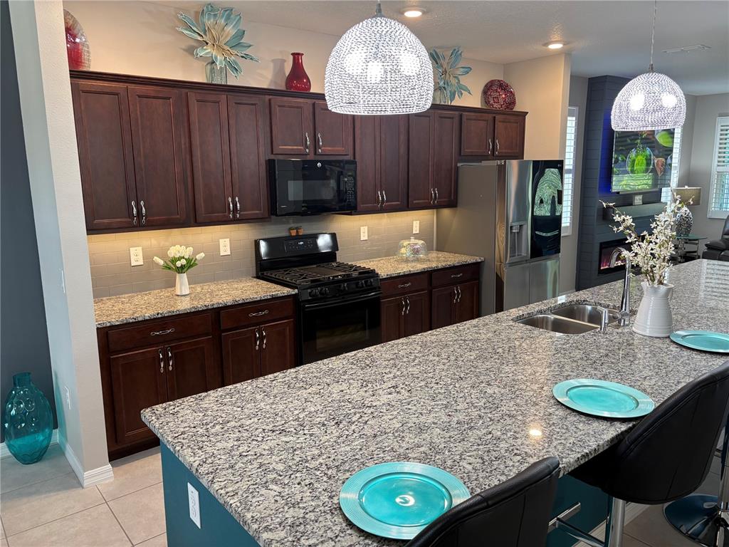 7819 Southwest 88th St Road Ocala, FL 34476 - Photo 10 of 30 a kitchen with kitchen island granite countertop a sink cabinets and window