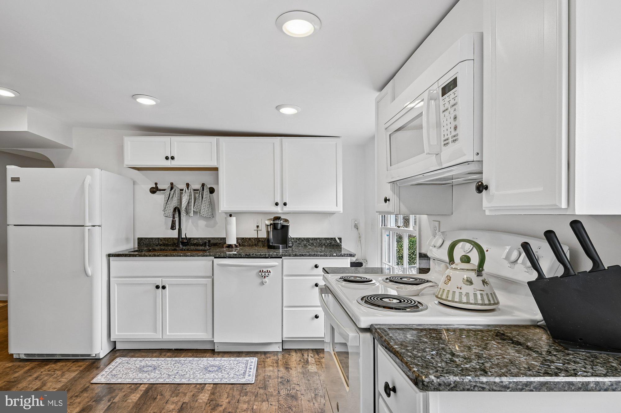 8 Fleet Street Annapolis, MD 21401 - Photo 19 of 37 a kitchen with granite countertop a sink a stove a refrigerator and cabinets