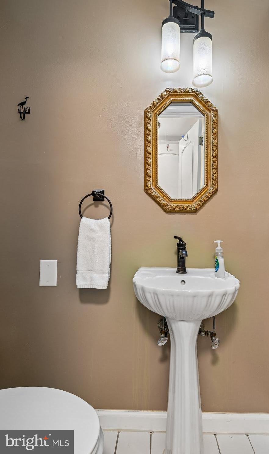 8 Fleet Street Annapolis, MD 21401 - Photo 22 of 37 a bathroom with a toilet sink and mirror