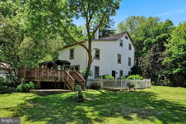 a front view of house with a garden