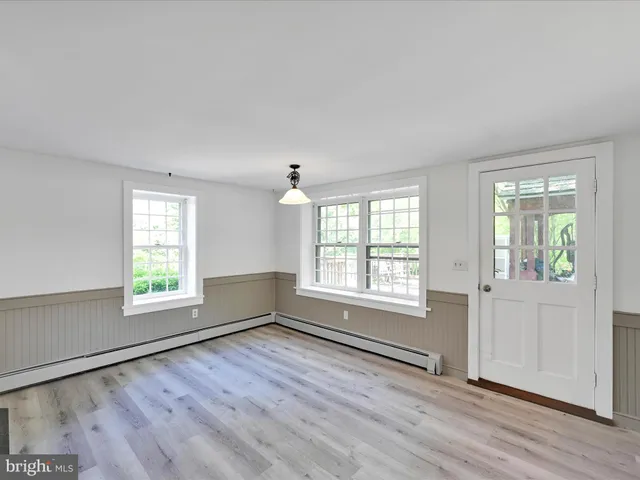 a large kitchen with granite countertop a large window a sink and stainless steel appliances