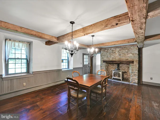 a view of a room with furniture and wooden floor