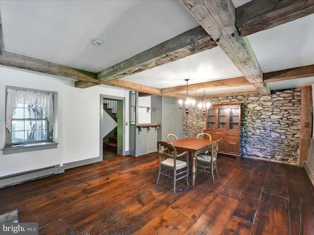 a living room with a stove and a wooden floor