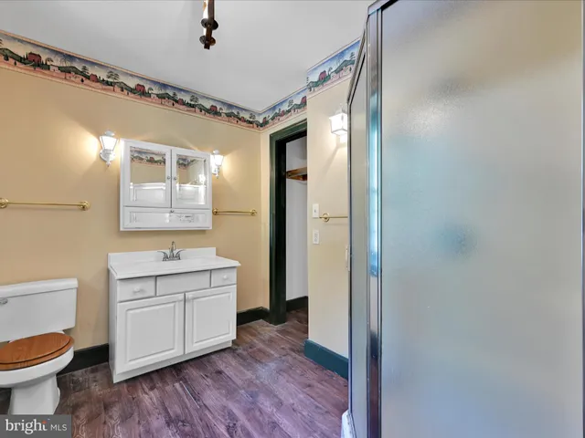 a view of an entryway with wooden floor and stairs