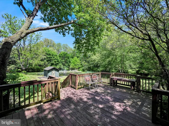 a view of a wooden house with a yard