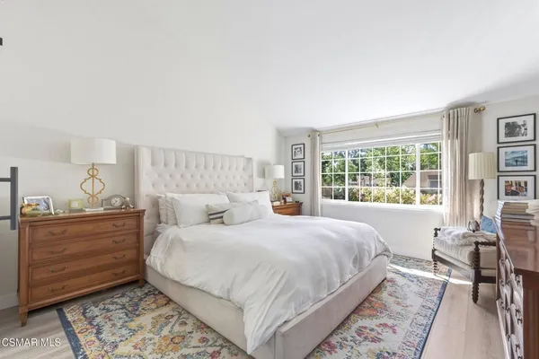a bedroom with a large bed and a window