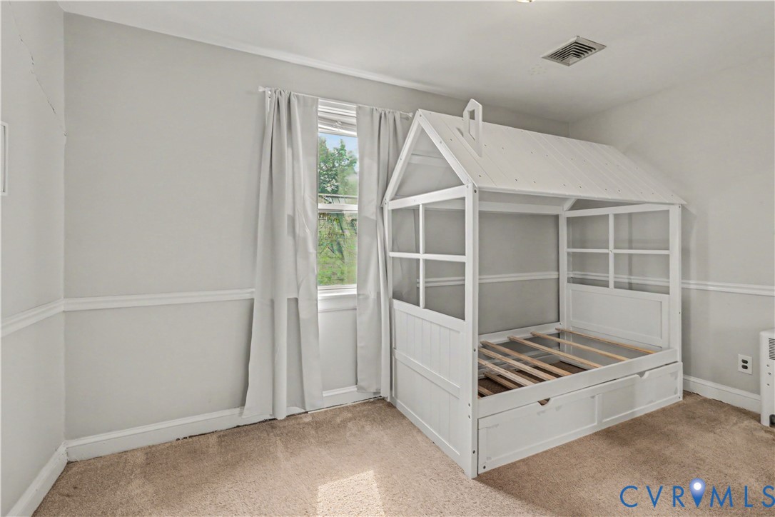4803 Coleman Road Richmond, VA 23230 - Photo 23 of 54 Room featuring a window, wall trim, and neutral-to