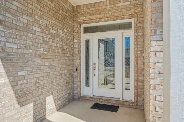 a view of a dining room with furniture a chandelier and wooden floor