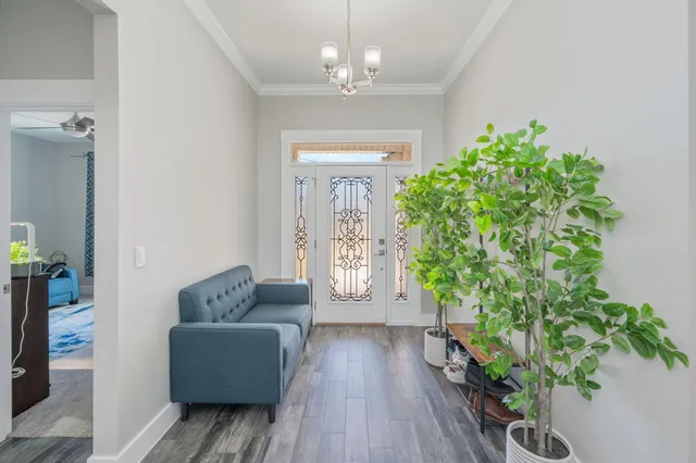a living room with a couch and a table with wooden floor