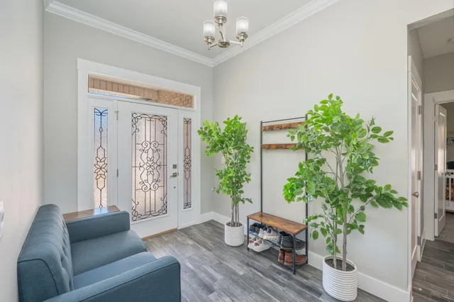 a living room with furniture and a wooden floor