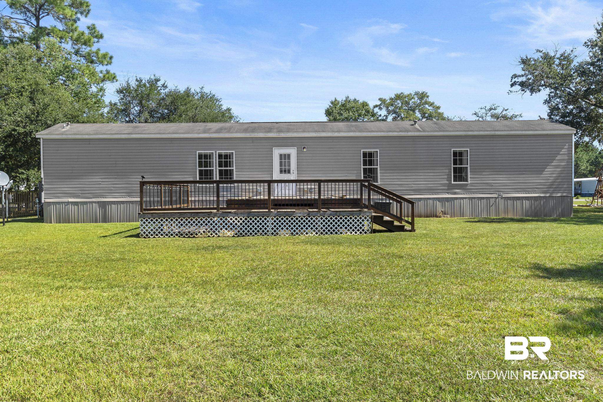 6870 Cecilia Court Theodore, AL 36582 - Photo 11 of 83 Rear view of house featuring a yard and a wooden deck