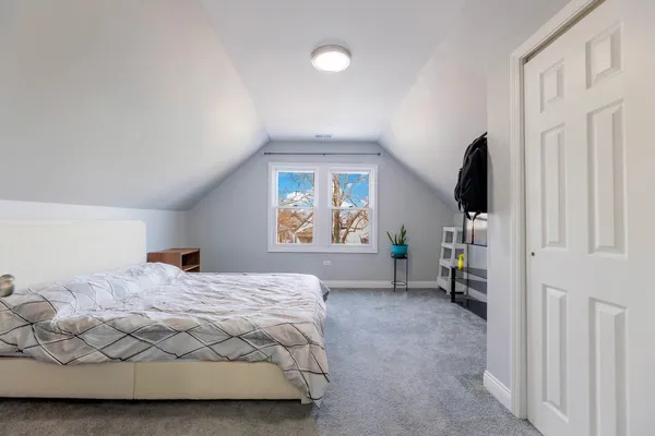 a bedroom with a bed next to a window with outer view