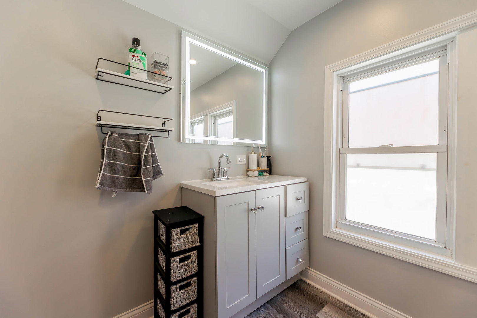 1473 West 73rd Street Chicago, IL 60636 - Photo 17 of 28 a bathroom with a sink a mirror and a window