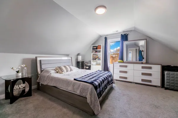 a bedroom with a bed and a dresser