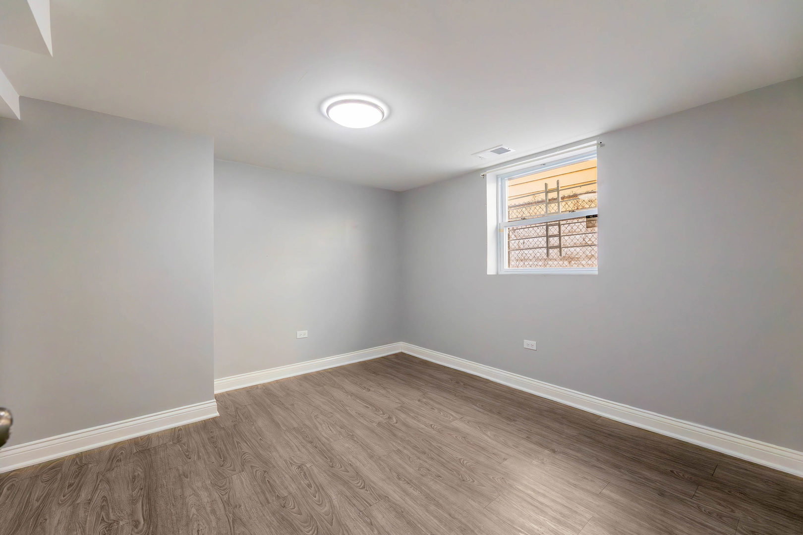 1473 West 73rd Street Chicago, IL 60636 - Photo 20 of 28 an empty room with wooden floor and windows