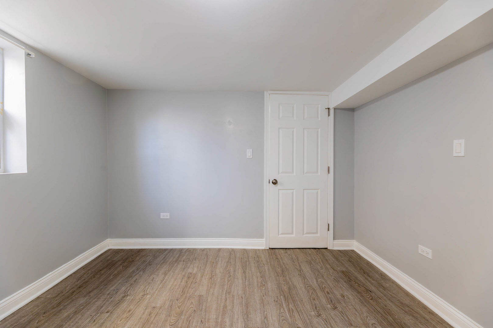 1473 West 73rd Street Chicago, IL 60636 - Photo 21 of 28 a view of an empty room with wooden floor and a window