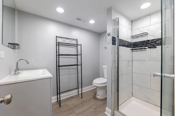 a bathroom with a toilet sink and shower