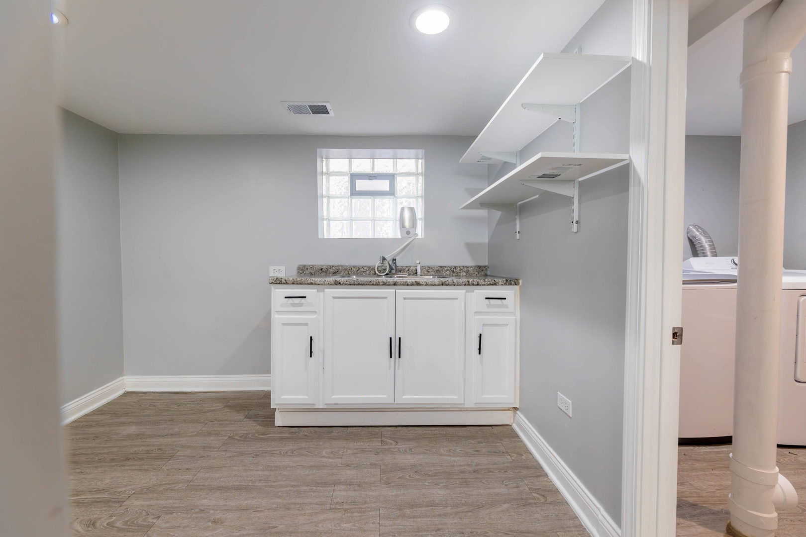 1473 West 73rd Street Chicago, IL 60636 - Photo 24 of 28 a view of cabinets a sink and wooden floor