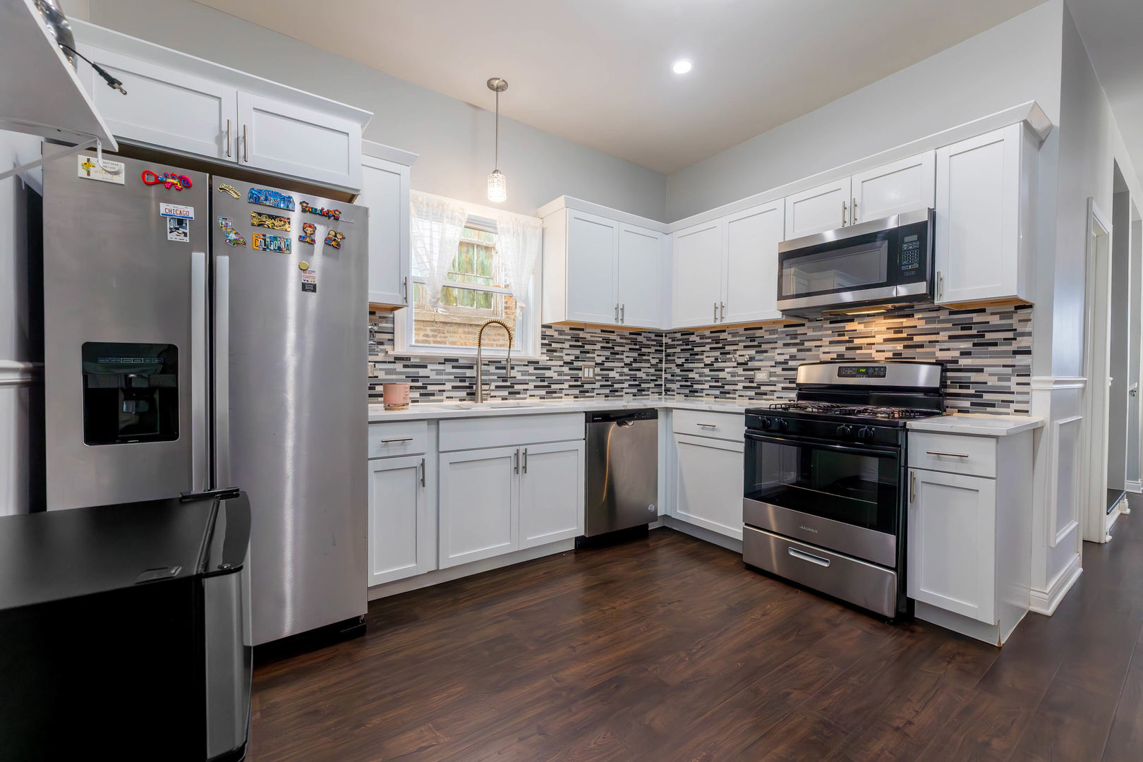 1473 West 73rd Street Chicago, IL 60636 - Photo 8 of 28 a kitchen with stainless steel appliances a refrigerator stove and microwave