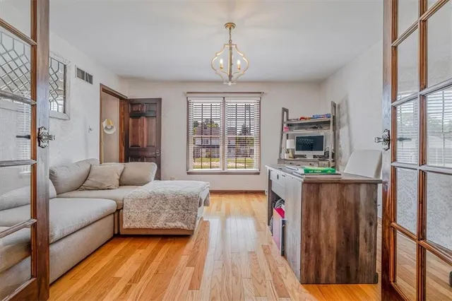 a living room with a bed furniture and a flat screen tv