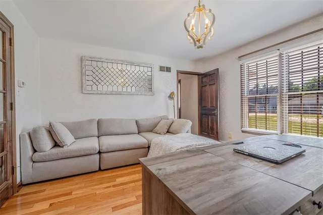 a large bedroom with bed and large windows