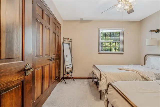 a spacious bedroom with a bed and a window