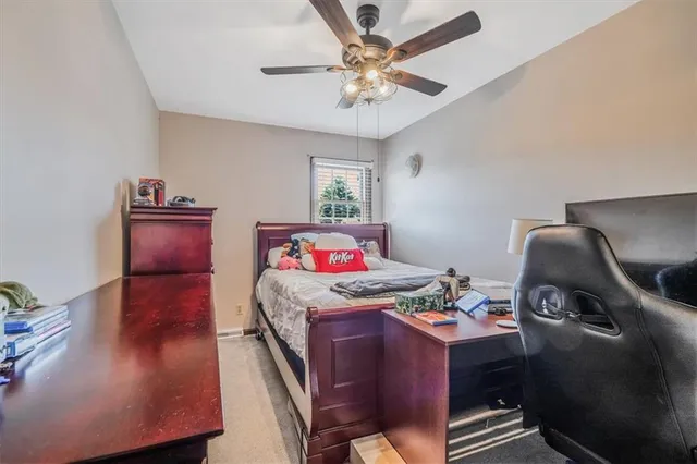 a bedroom with bed and a chandelier