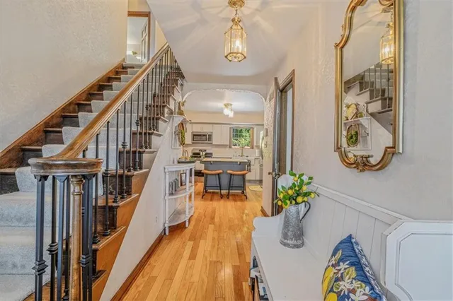 a view of entryway and hall with wooden floor