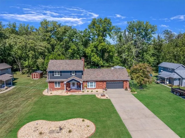 aerial view of a house with garden space and street view
