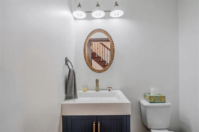 a kitchen with a refrigerator a stove a sink and a stove with wooden floor