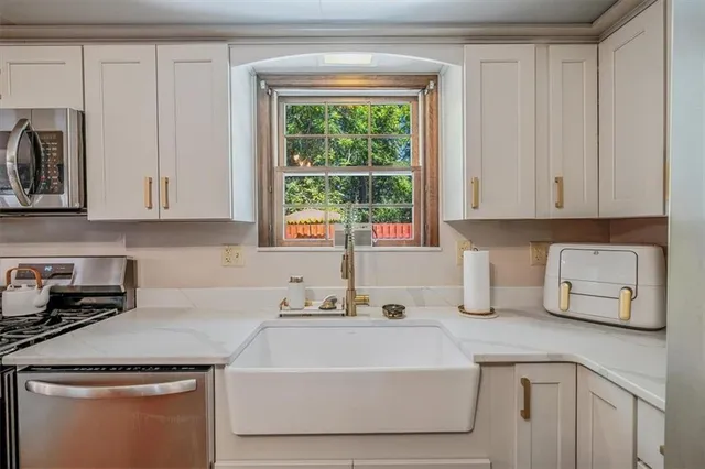 a room with a bed a mirror and a window